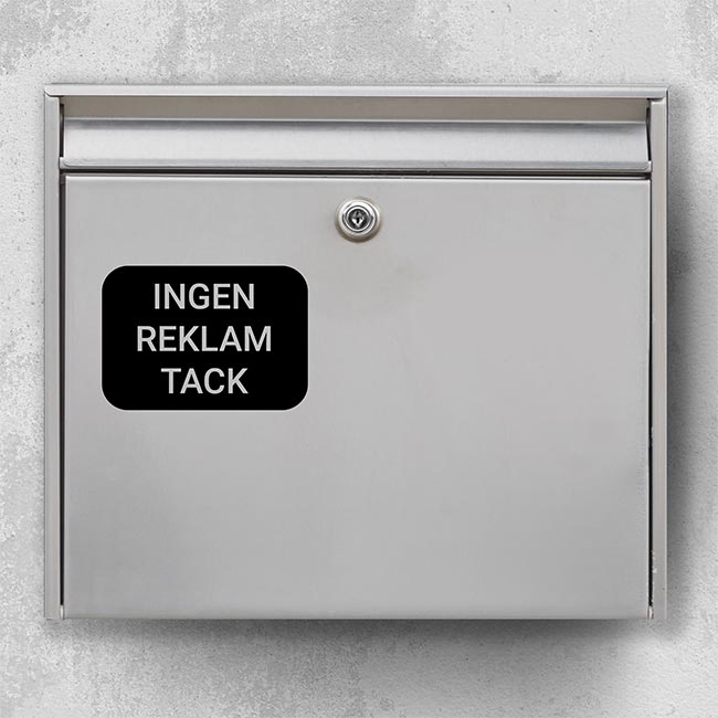 Mailbox sticker “No ads, please” – black, rectangular with rounded corners on silver mailbox